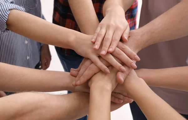 Young people putting hands together — Stock Photo, Image