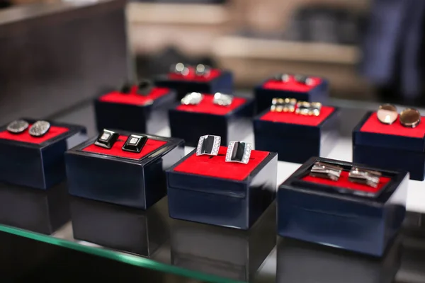 Boxes with cufflinks on shelf — Stock Photo, Image