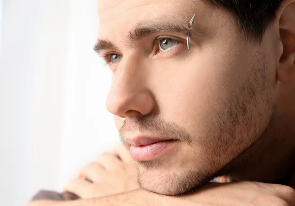 young man with pierced eyebrow