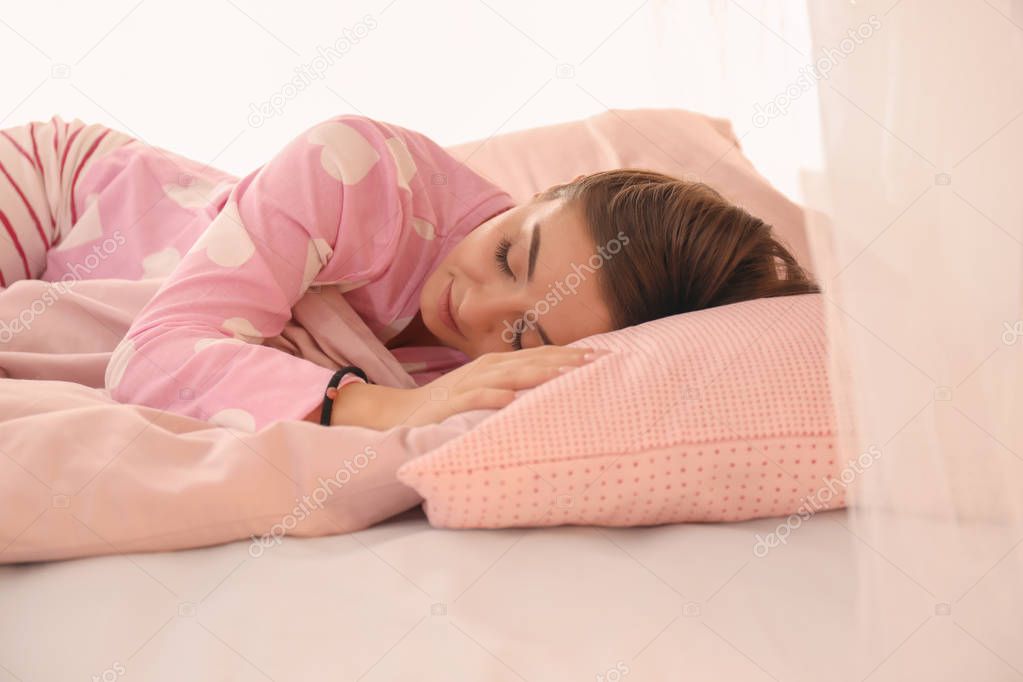 young woman sleeping in bed 