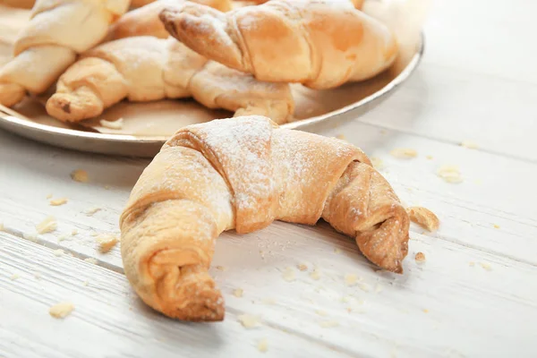 Tasty crescent roll on wooden table — Stock Photo, Image