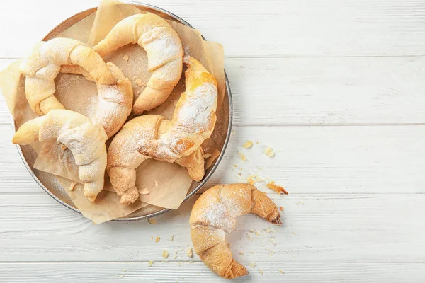 Plate with tasty crescent rolls on wooden table — Stock Photo, Image