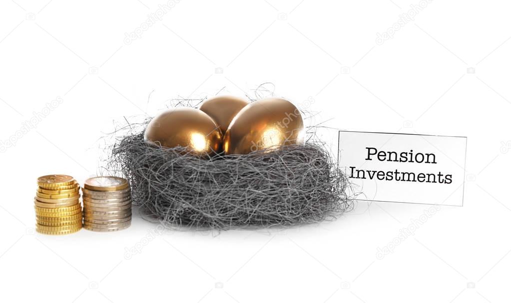 Nest with golden eggs, coins and sign PENSION INVESTMENTS on white background