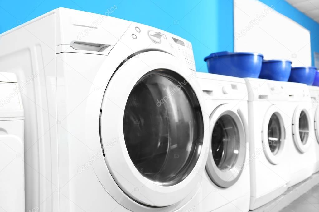 Industrial laundry machines in laundromat