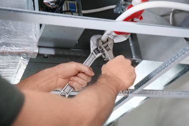 technician repairing air conditioner clipart