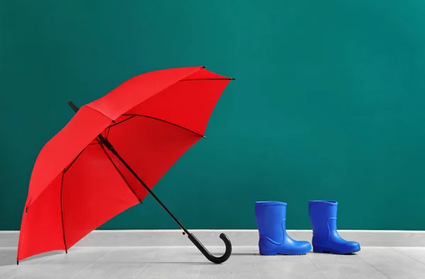 Red umbrella and rubber boots — Stock Photo, Image