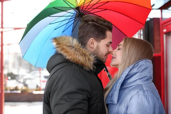 Romantic couple with colorful umbrella — Stock Photo, Image