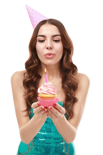 Young woman snuffing out candle — Stock Photo, Image