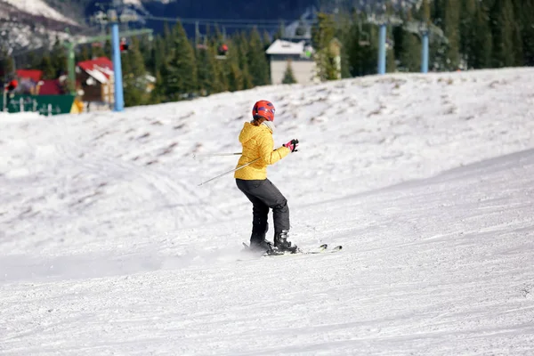 Femme skiant sur piste à la station enneigée. Vacances d'hiver — Photo