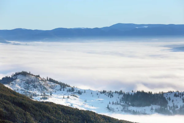 Beautiful landscape with foggy mountains in wintertime