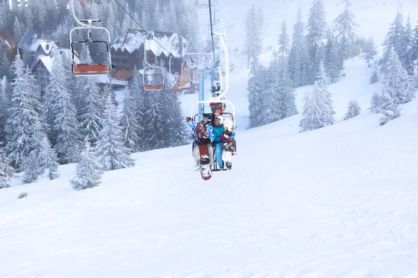 Couple on ski lift at mountain resort. Winter vacation — Stock Photo, Image