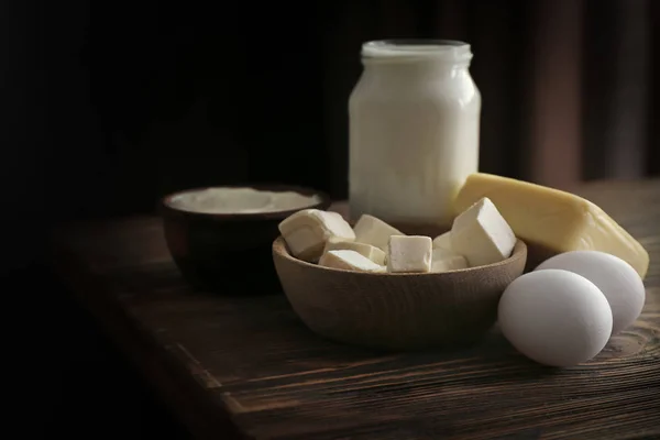 Fresh dairy products and eggs on wooden table