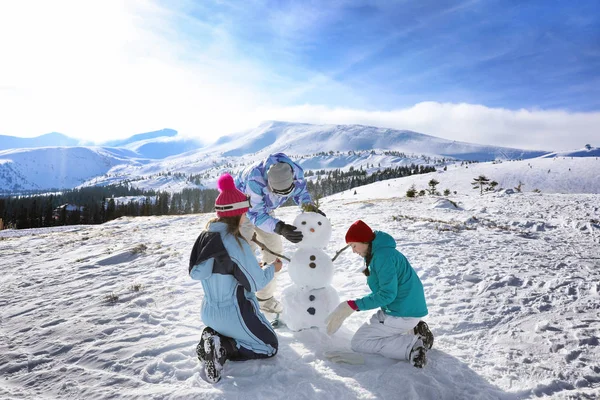 Grupp Vänner Att Göra Snögubbe Ski Resort — Stockfoto