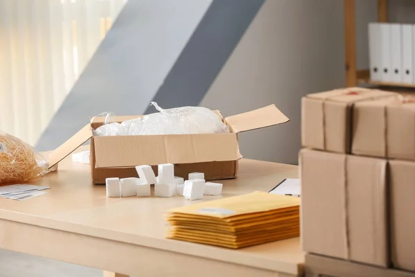 Open parcel box on table in home office