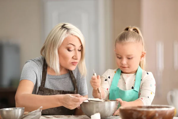 小女孩和她的祖母在厨房筛面粉到碗里 — 图库照片