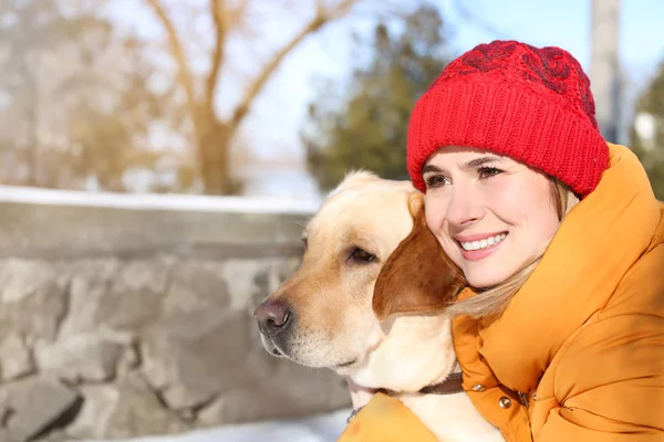 Woman with cute lovely dog outdoors on winter day. Friendship between pet and owner — Stock Photo, Image