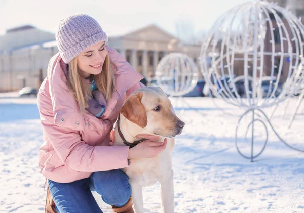 Woman with cute dog outdoors on winter day. Friendship between pet and owner — Stock Photo, Image