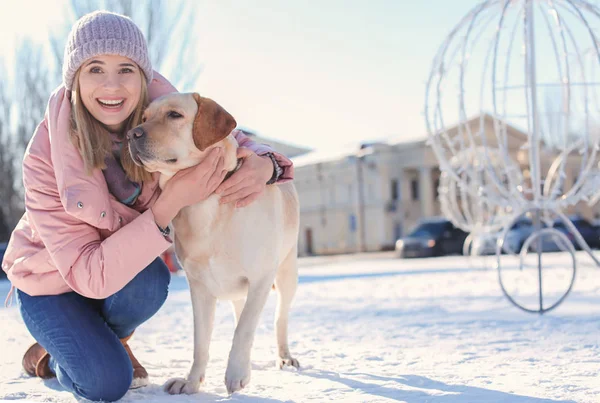 Woman with cute dog outdoors on winter day. Friendship between pet and owner — Stock Photo, Image