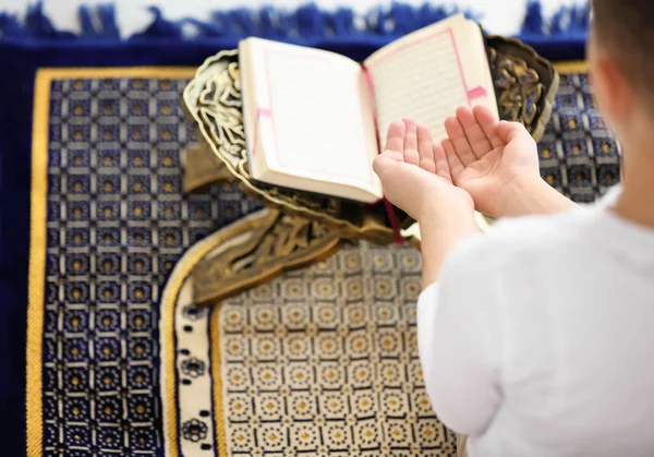 Young Muslim man praying on rug, closeup — Stock Photo, Image