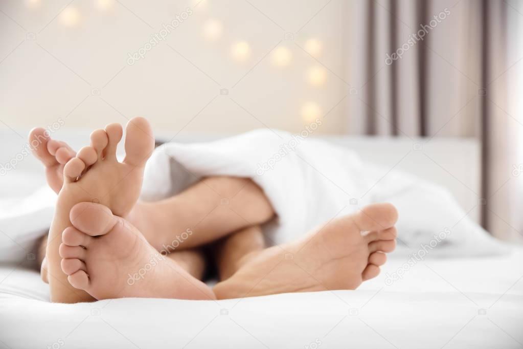 gay couple lying on bed