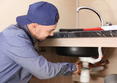 plumber replacing sink trap  clipart