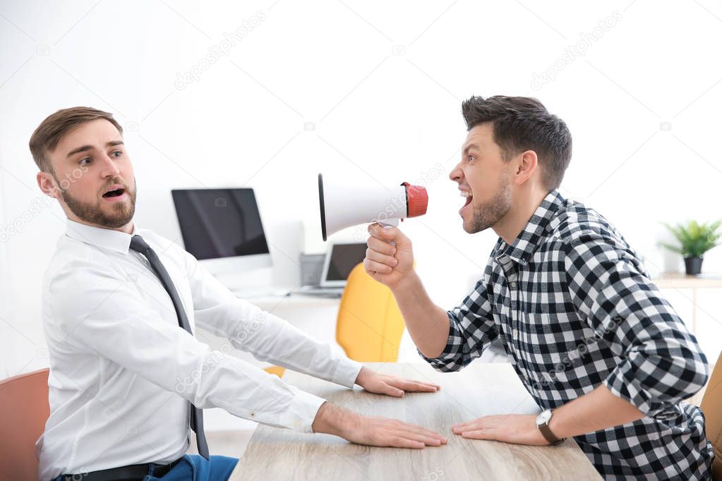 boss with megaphone screaming at employee