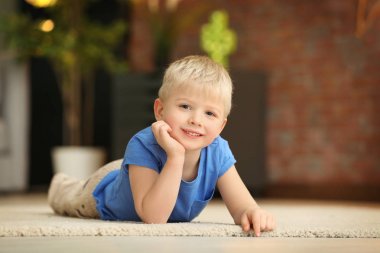 Evde yerde yatarken şirin küçük çocuk