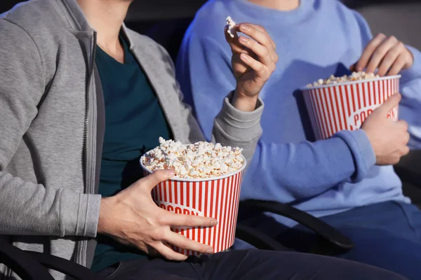 Young men with tasty popcorn — Stock Photo, Image