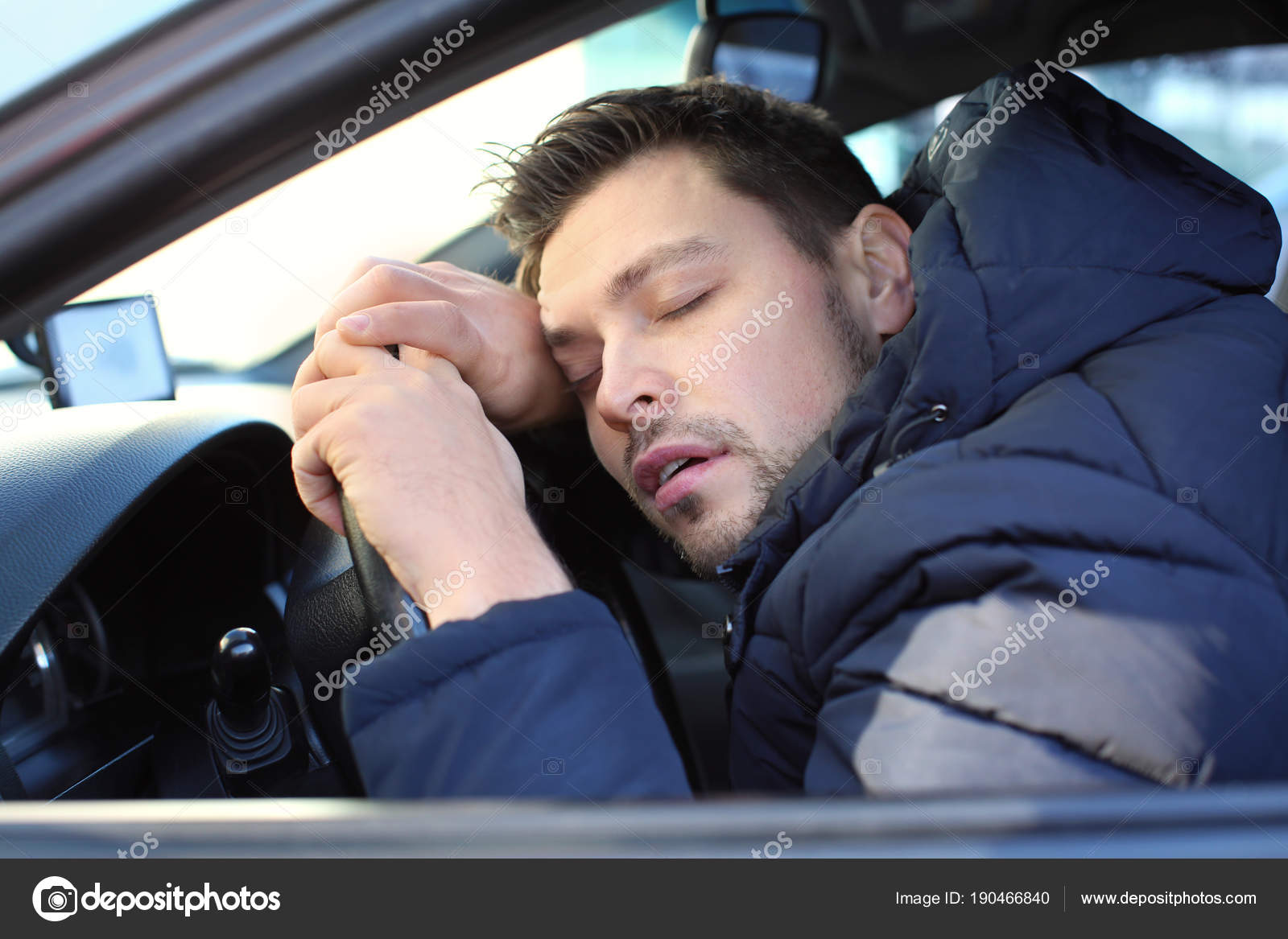 Young man sleeping inside car Stock Photo by ©belchonock 190466840