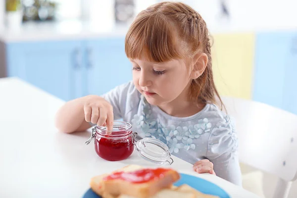 Little girl with jar of jam — Stock Photo, Image