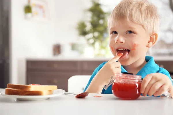 Little boy with jar of jam — Stock Photo, Image