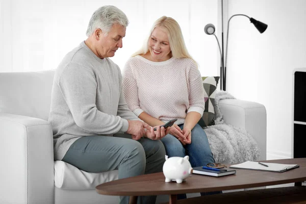 Mature couple thinking over pension plan at home
