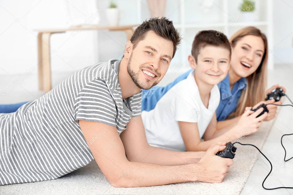 Happy family playing video games at home