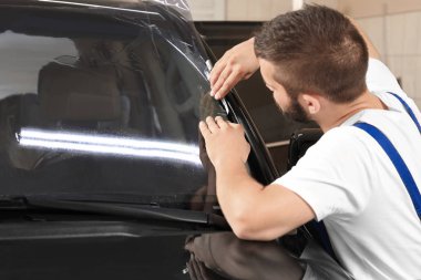 Worker tinting car window  clipart