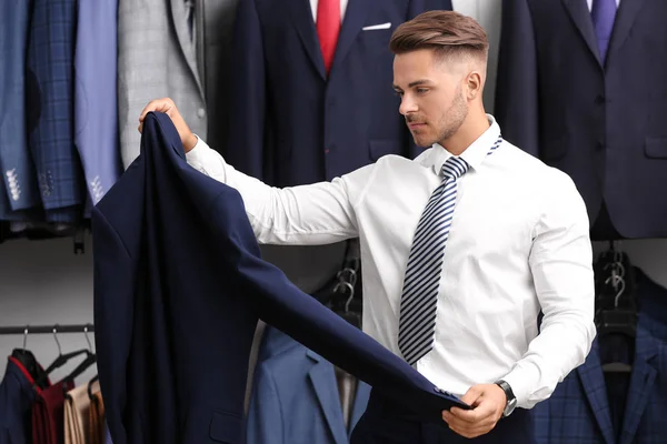 Young man choosing suit — Stock Photo, Image