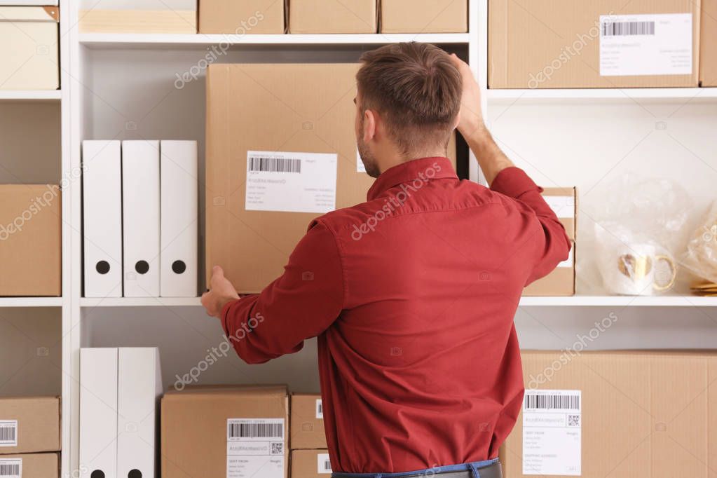 Young man preparing parcel