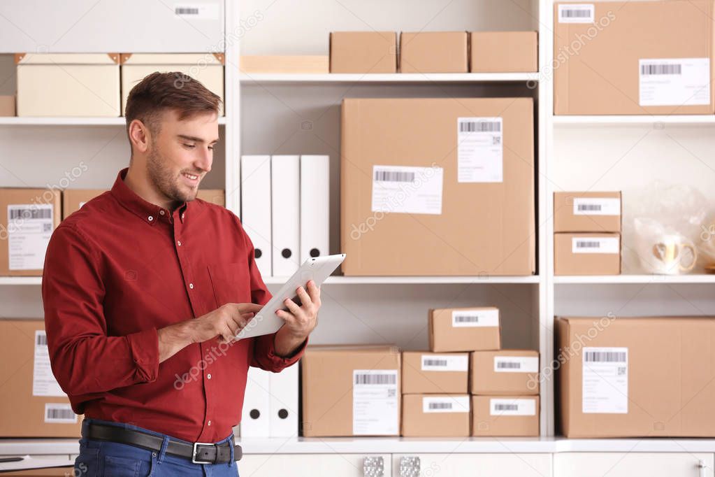 Young man preparing parcels