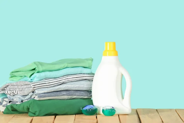 Stack of clothes and laundry detergent — Stock Photo, Image