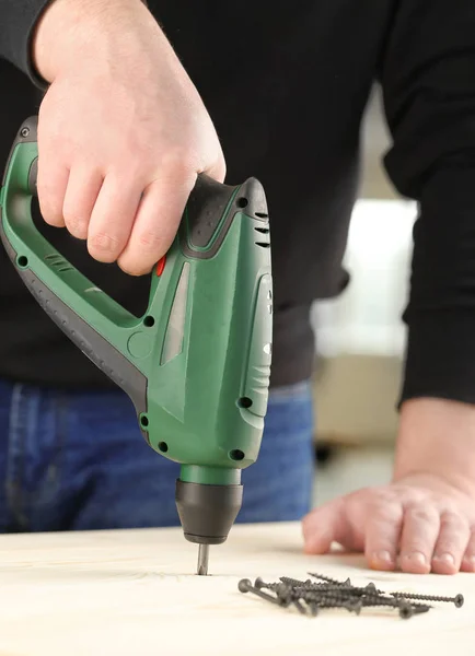 Carpenter working with electric equipment — Stock Photo, Image