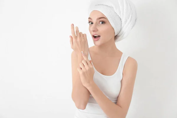 Jeune Femme Appliquant Crème Pour Les Mains Sur Fond Blanc — Photo