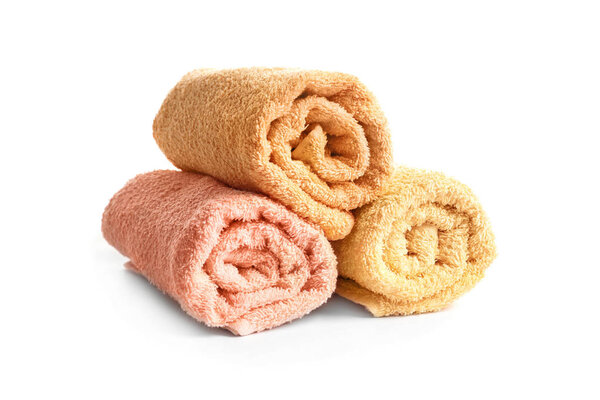 Rolled clean terry towels on white background
