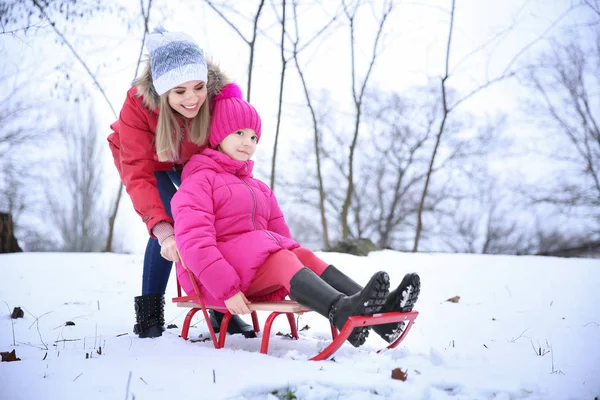 Happy Mother Daughter Sledding Snowy Park Winter Vacation — Stock Photo, Image