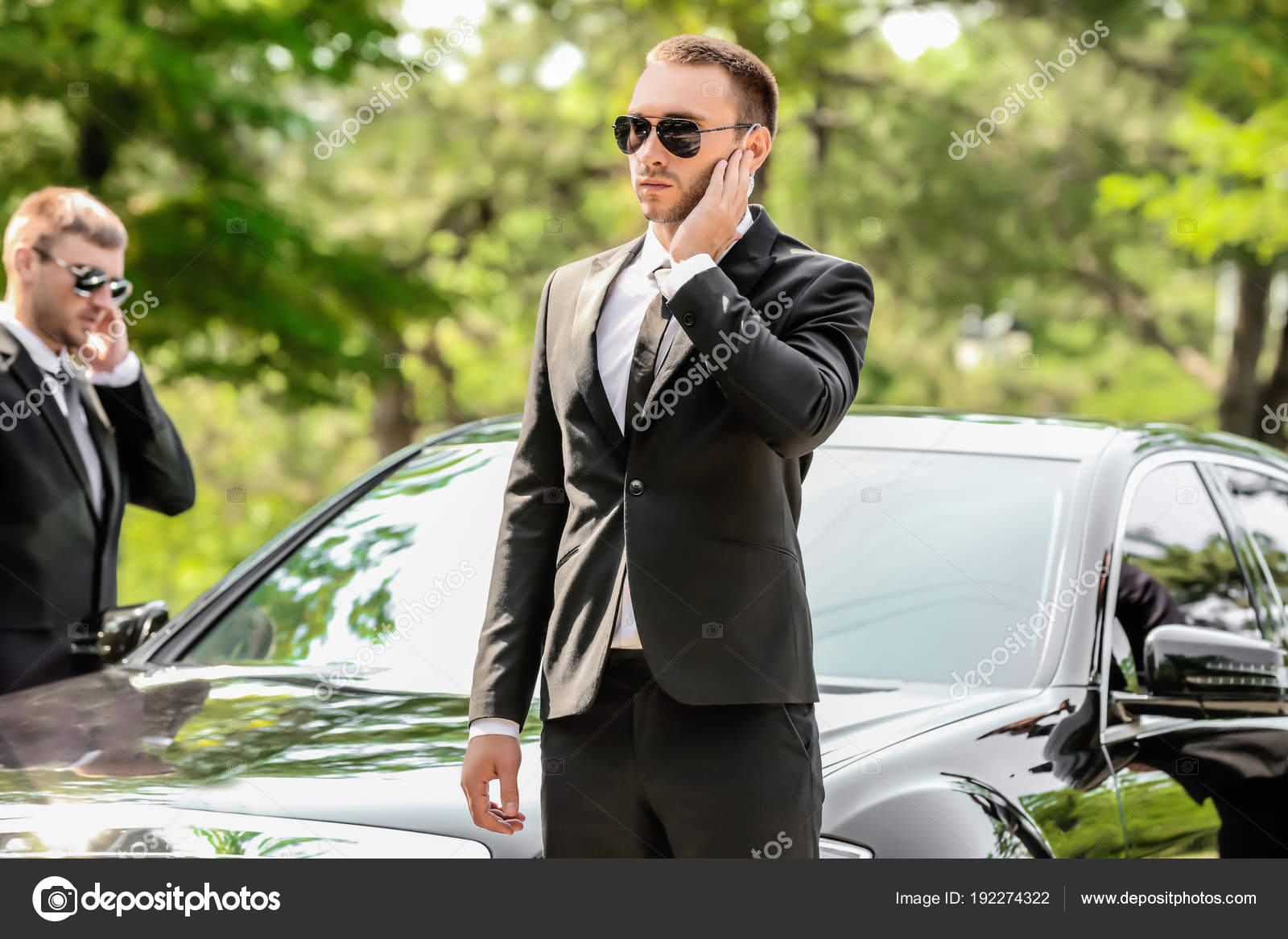 Handsome bodyguards near car Stock Photo by ©belchonock 192274322