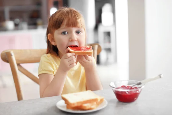 少女ジャム付きトーストを食べます — ストック写真