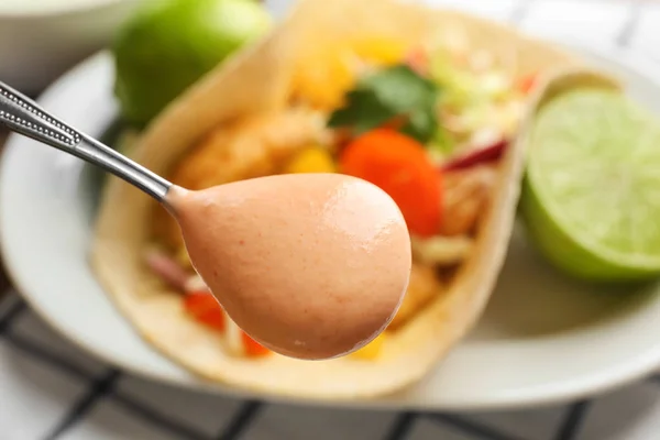 Spoon with tasty creamy sauce — Stock Photo, Image