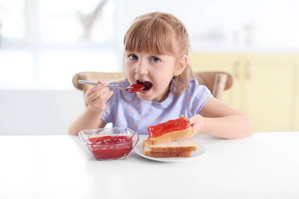little girl eating jam