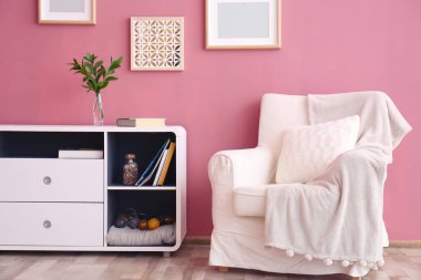 Zarif odası iç renk duvarının yakınında konforlu koltuk ile