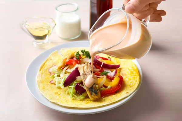 Woman Pouring Tasty Creamy Sauce Fish Taco Kitchen Table — Stock Photo, Image