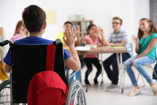 Boy in wheelchair with classmates