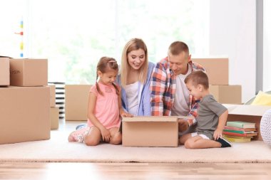 Mutlu aile/açma karton kutunun içinde yeni evinde Oda